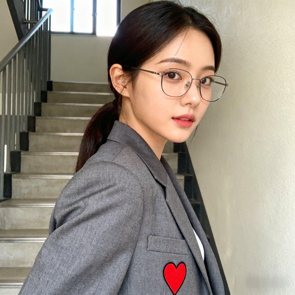 white woman, side profile close-up, girl with cartoon hat, face covered by sweater, green plant back